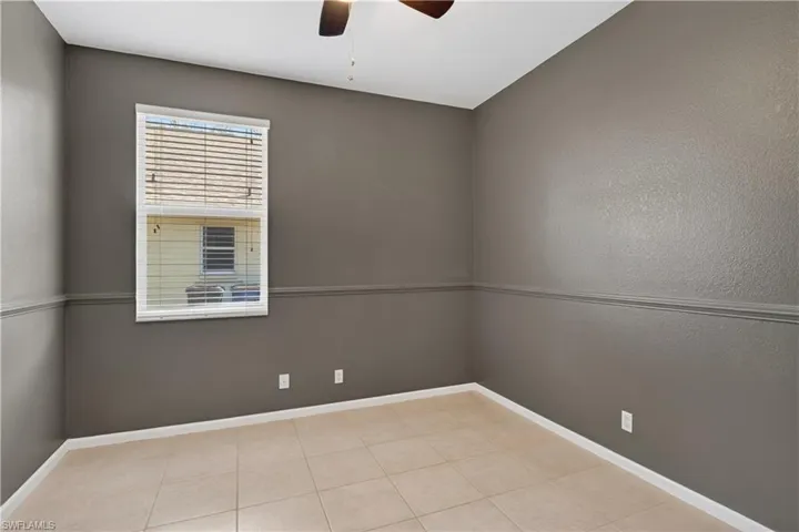 Empty room with ceiling fan and a textured wall