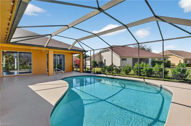 Swimming pool with a sunroom, a patio area, and a lanai