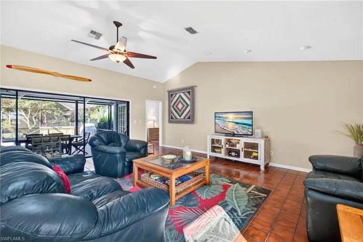 Large sliding glass doors in the great room providing easy access to the screened lanai and pool area.