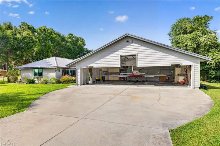 Existing hangar provides 1280 sq ft of space. Interior measurements 38' wide and 30' deep. The door is 37' wide, center tail height is 10'8", and left and right door heights are 6'9". Seller has a set of plans to expand the hangar forward an additional 12'.