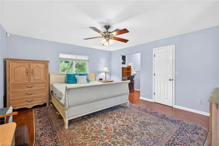 Primary bedroom with walk in closet and a separate alcove area for a small desk or workspace.