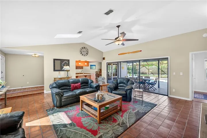 Spacious Great Room with a vaulted ceiling, sky light and a wonderful view of the screened in lanai and pool!