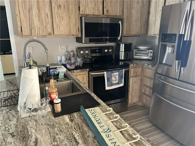 Kitchen featuring stainless steel appliances and sink