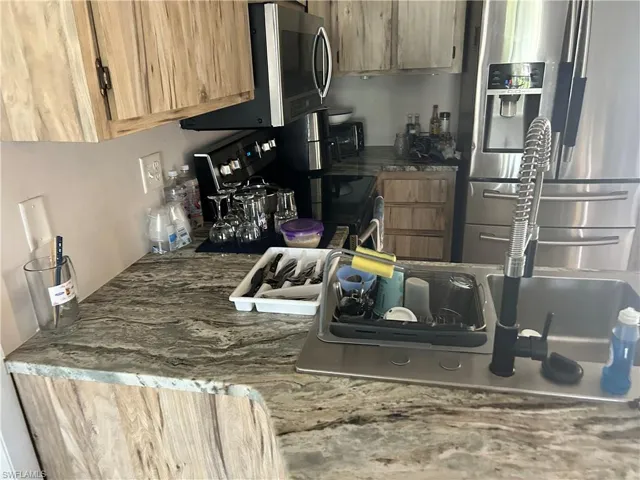 Kitchen with appliances with stainless steel finishes