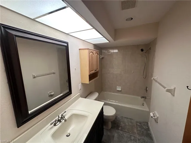 Full bath with vanity and bathtub / shower combination