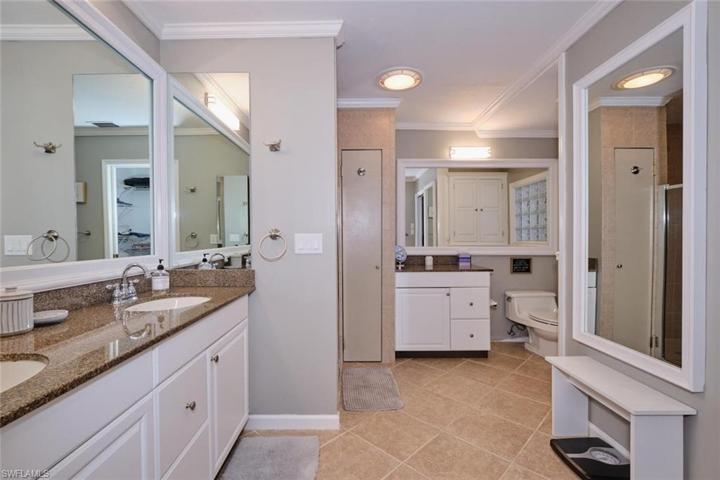 Master bath has dual sinks, walk-in tiled shower, tile floors.