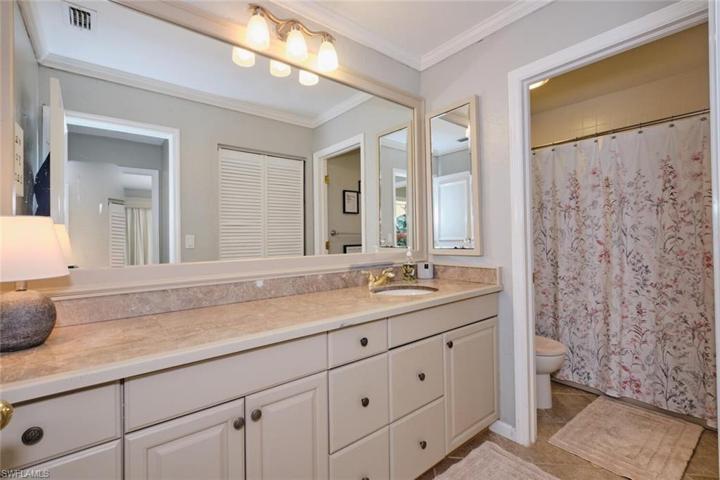 Guest bath has plenty of vanity space, tub/shower combo, tile floors.