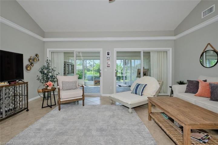 Great room has two sets of sliders out to the glass porch.