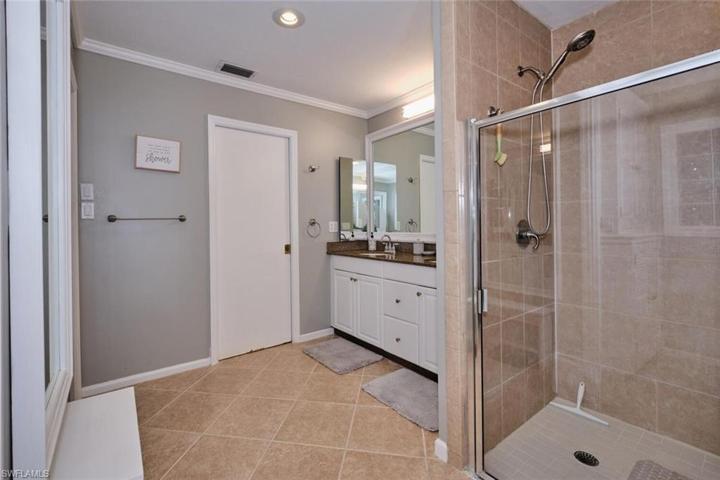 Large master bath has tiled shower, large walk-in closet, crown molding.