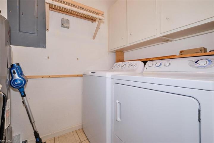 Unit features a full size washer and dryer with storage cabinetry.