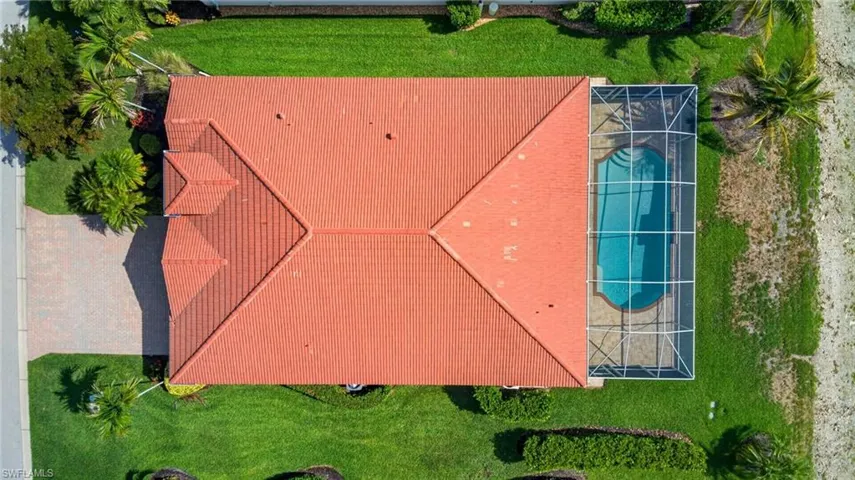 Red tile roof architecture with a screened-in swimming pool
