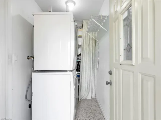 Dedicated laundry area featuring a stacked washer and dryer