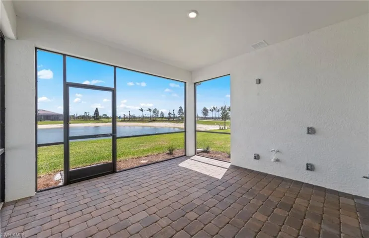 Unfurnished sunroom featuring a water view