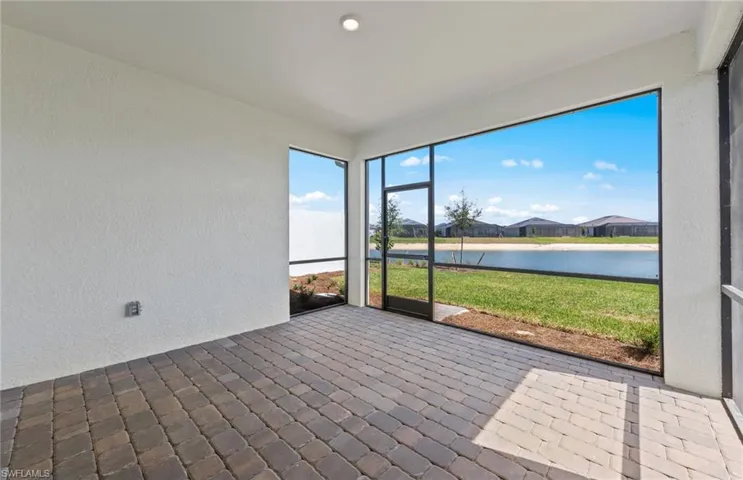 Unfurnished sunroom featuring a water view
