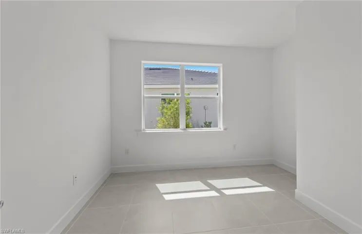 Unfurnished room with light tile floors