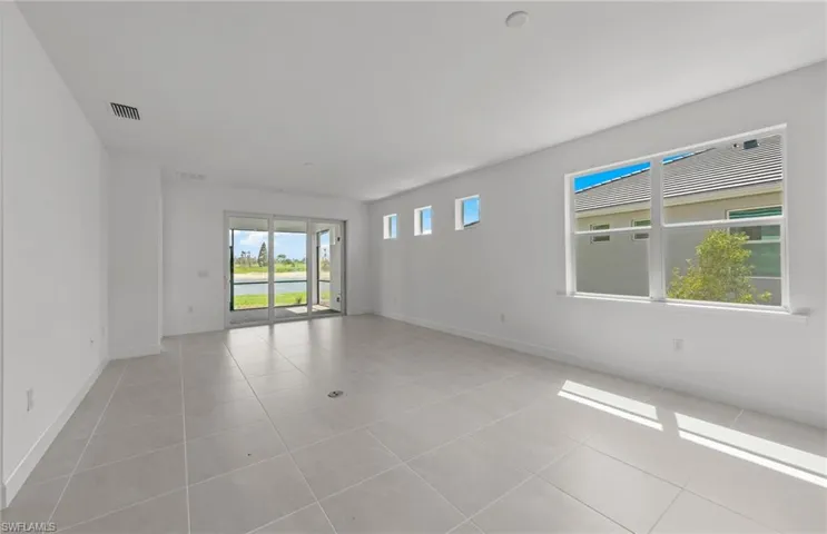 Empty room with light tile floors