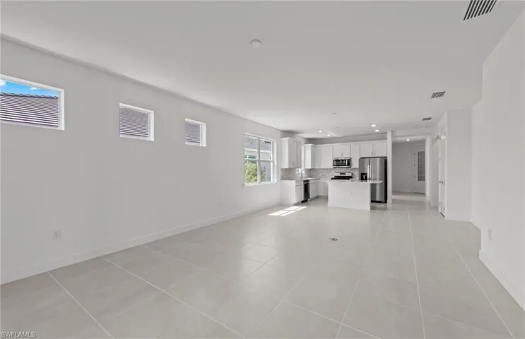 Unfurnished living room with light tile floors