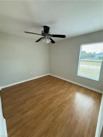 Spare room with light wood-type flooring and baseboards