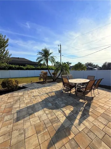 Fenced backyard with a patio area and outdoor dining area