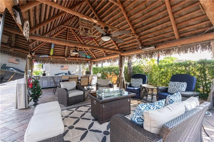 View of patio with ceiling fan, an outdoor kitchen, and an outdoor hangout area