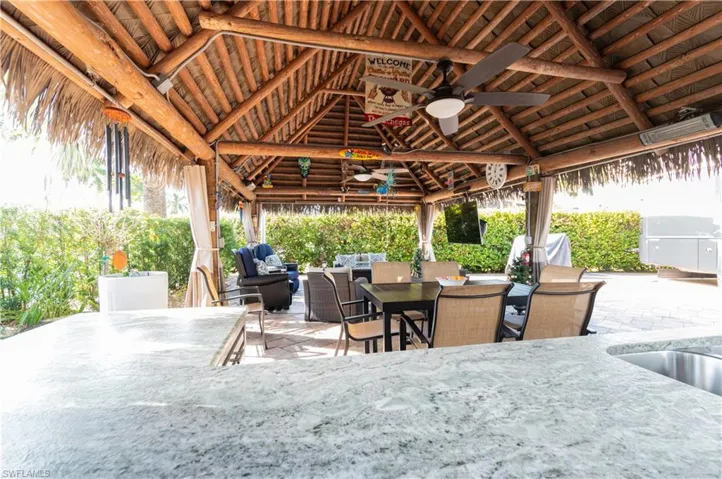 View of patio featuring ceiling fan, outdoor dining area, and an outdoor hangout area
