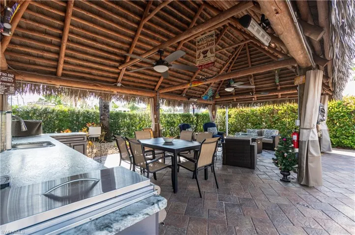 View of patio featuring ceiling fan, outdoor dining space, an outdoor living space, and grilling area