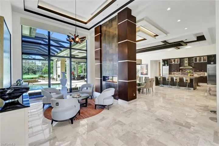 Entering the Foyer your eyes are drawn to the double sided fire place and incredible open concept entertaining space!