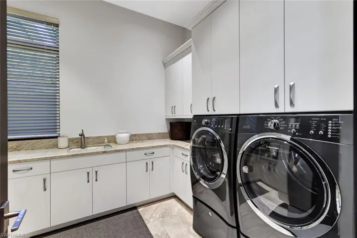 Amazing space in this utility room with ample counter and cabinet space!