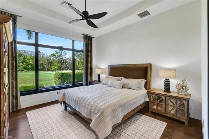 Guest bedroom #3 with tray ceiling and oversized window overlooking a peaceful view of the course!
