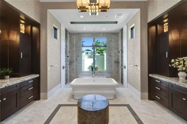 Primary spa bathroom with separate sink + vanities with a lovely walk-in shower