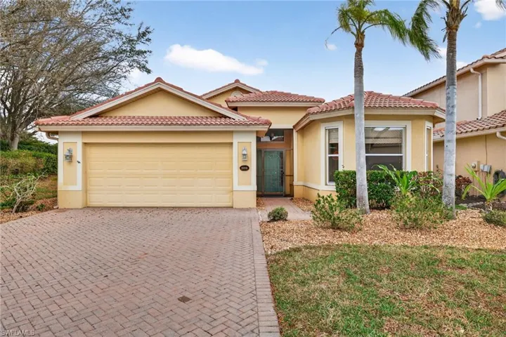 Mediterranean / spanish-style house with stucco siding, decorative driveway, and an attached garage