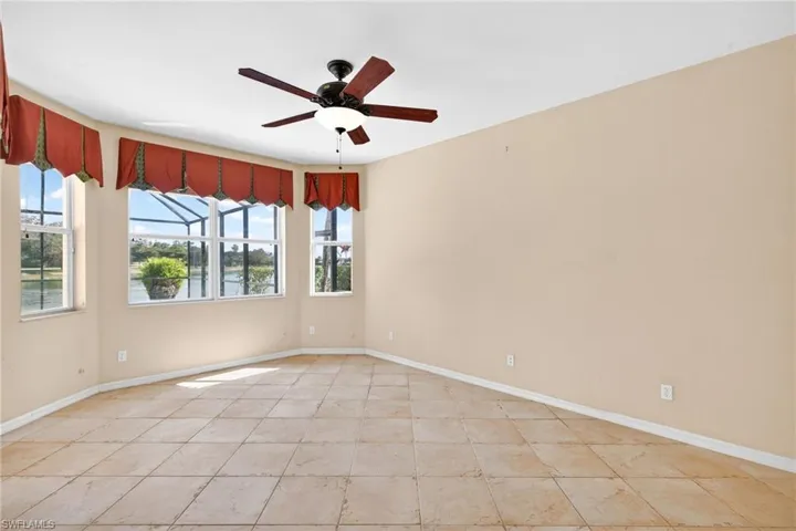 Empty room with a ceiling fan and a water view