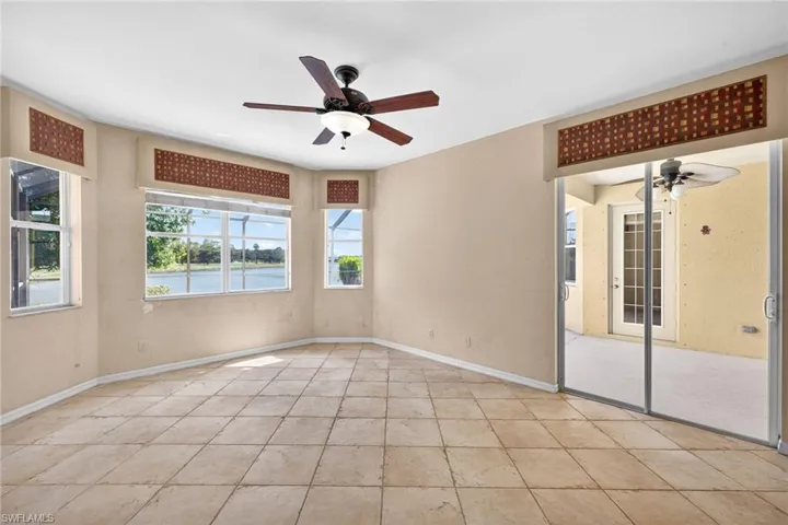 Empty room with a ceiling fan and a water view