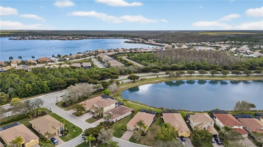 Aerial perspective of suburban area featuring a large body of water