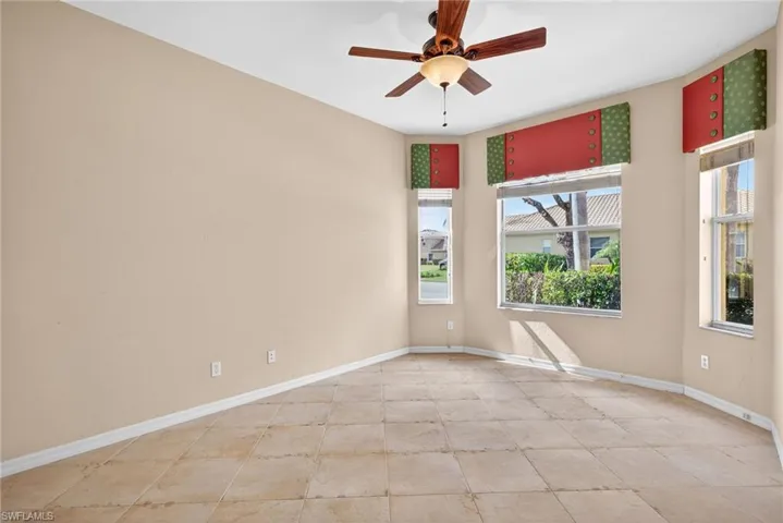 Unfurnished room with a ceiling fan and baseboards
