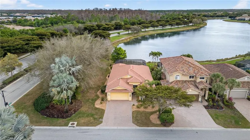 Aerial perspective of suburban area featuring a nearby body of water