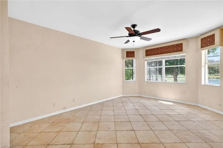 Spare room featuring ceiling fan and baseboards