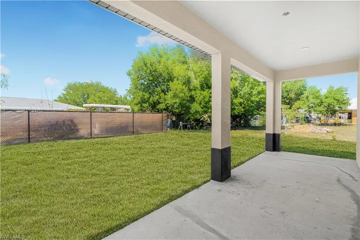 View of yard with a patio area and fence