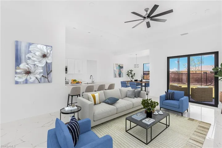 Living area featuring visible vents, marble finish floor, and ceiling fan
