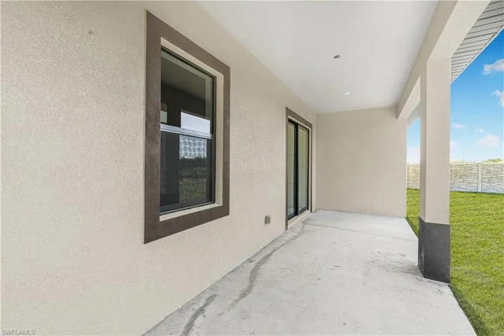 View of patio featuring fence