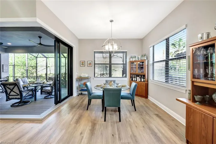 Dining room with notable chandelier and zero corner sliding glass doors