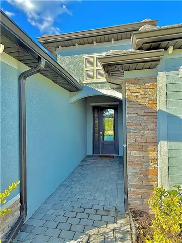 Entrance to property with stucco siding