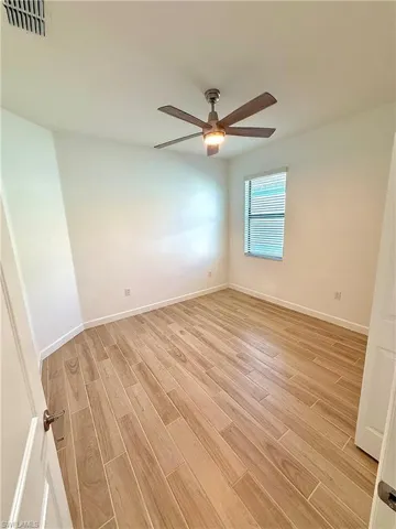 Unfurnished room featuring light wood-style floors and baseboards