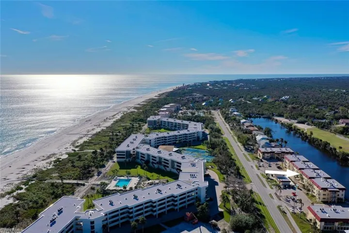 Aerial view of unending shoreline and apartment complex / building