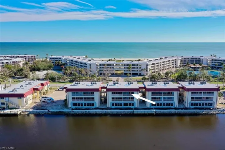 Aerial view of apartment complex / building and a large body of water