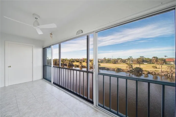 Unfurnished sunroom with a water view and a residential view