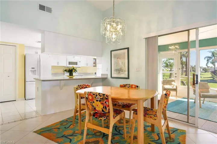 Dining room featuring suspended lighting, a high ceiling, and light tile patterned floors