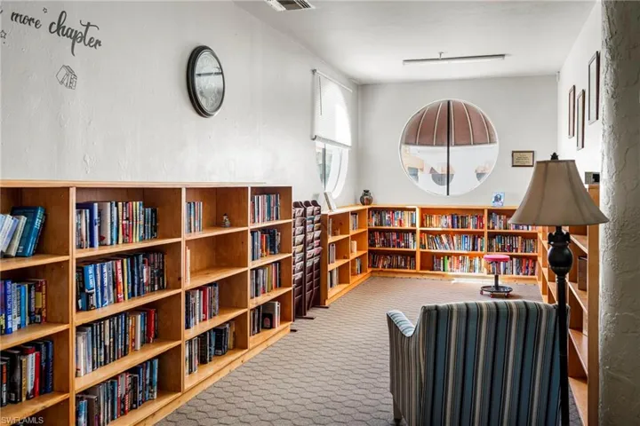 Sitting room with bookshelves and light carpet