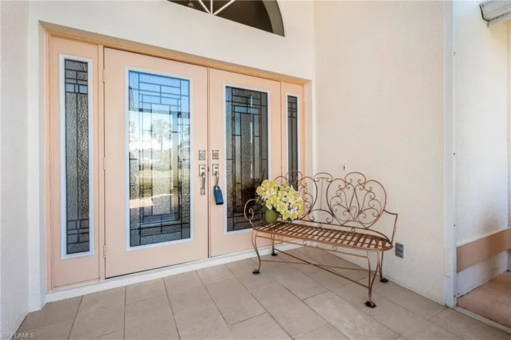 Doorway to property with french doors and stucco siding