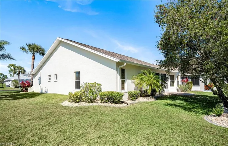 View of home's exterior featuring a lawn and stucco siding